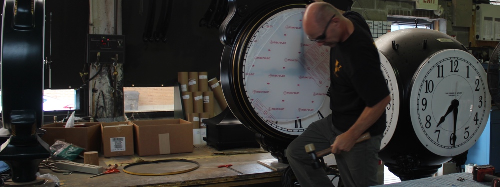 craftsman working on a large clock